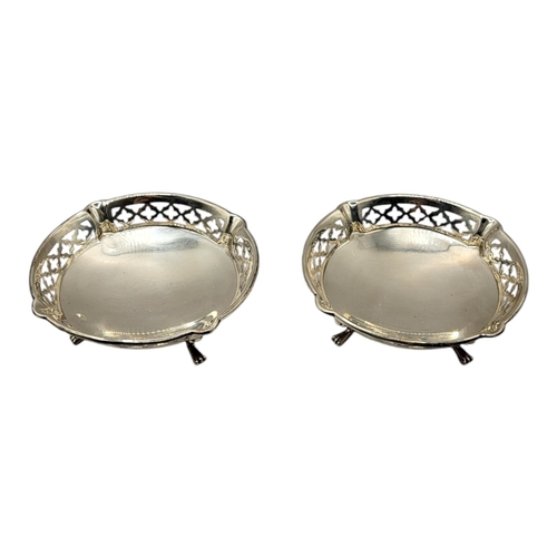 48 - A PAIR OF EARLY 20TH CENTURY SILVER SWEETMEAT DISHES
Circular form with pierced border and four scro... 