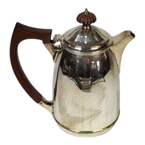 69 - AN EARLY 20TH CENTURY SILVER COFFEE POT
Having a carved wooden finial and chamfered design to body, ... 