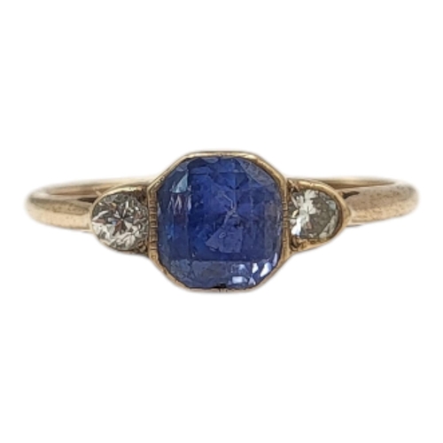 7 - A VINTAGE YELLOW METAL, SAPPHIRE AND DIAMOND RING
The central octagonal cut sapphire flanked with di... 