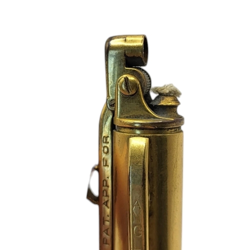 7A - ANGLIA, AN EARLY 20TH CENTURY YELLOW METAL COMBINATION CIGARETTE LIGHTER AND PROPELLING PENCIL
Marke... 