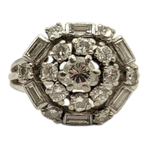 29A - A VINTAGE WHITE METAL AND DIAMOND RING
Having an arrangement of round cut diamonds edge with baguett... 