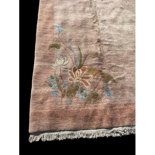 166 - A LARGE CHINESE WOOLLEN RUG
Plain form, with floral design to four corners.
(approx 299cm x 497cm)

... 