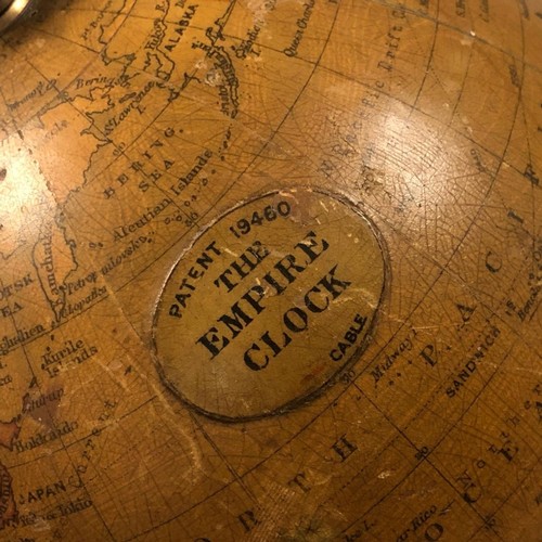 388 - AN EDWARDIAN EMPIRE GLOBE CLOCK
Eight day, with world timer, on brass stand engraved with presentati... 