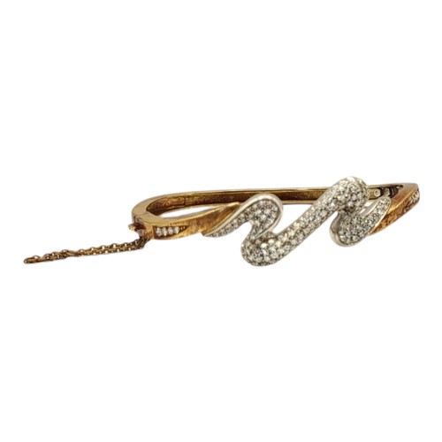 2B - A VINTAGE YELLOW METAL AND DIAMOND ‘LIGHTENING’ BANGLE
Having an arrangement of pave set diamonds an... 