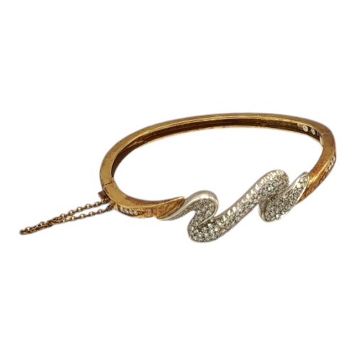 2B - A VINTAGE YELLOW METAL AND DIAMOND ‘LIGHTENING’ BANGLE
Having an arrangement of pave set diamonds an... 