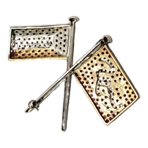 8B - AN 18CT WHITE METAL MULTI GEM FLAG BROOCH
Opposing flags, pave set with emerald, sapphire, diamond a... 