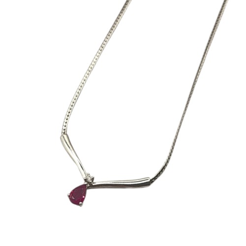 46A - A 14CT WHITE GOLD, RUBY AND DIAMOND PENDANT NECKLACE
The pear cut ruby set with a single diamond, in... 