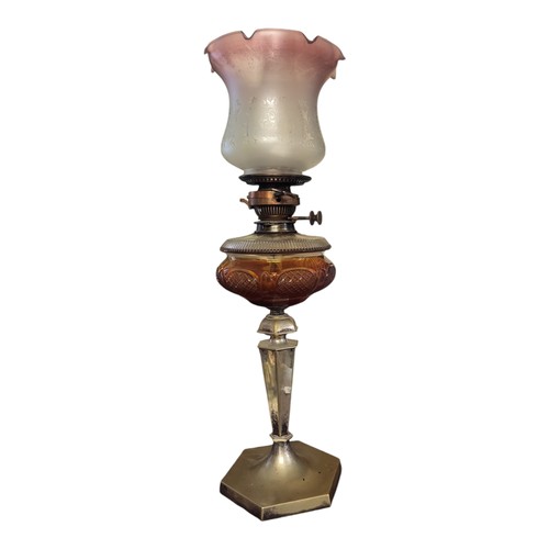 286 - A VICTORIAN BRASS AND CRANBERRY GLASS OIL LAMP
Having an etched spherical shade, cranberry oil well ... 