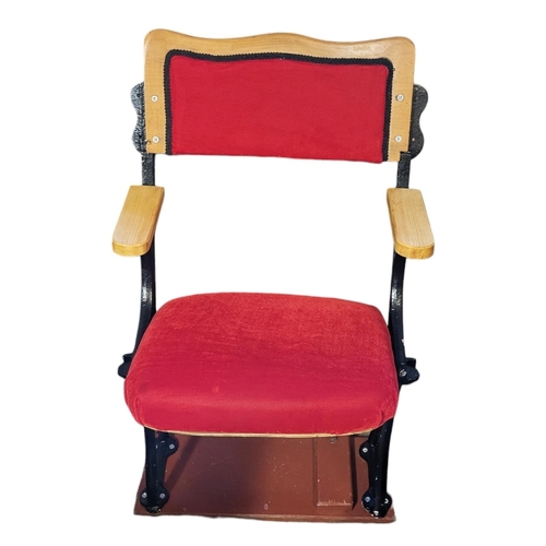 560A - A VINTAGE CAST IRON AND UPHOLSTERED SINGLE SEAT CINEMA CHAIR
The oak back support in a red velvet fa... 