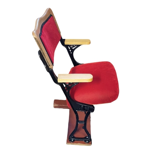 560A - A VINTAGE CAST IRON AND UPHOLSTERED SINGLE SEAT CINEMA CHAIR
The oak back support in a red velvet fa... 