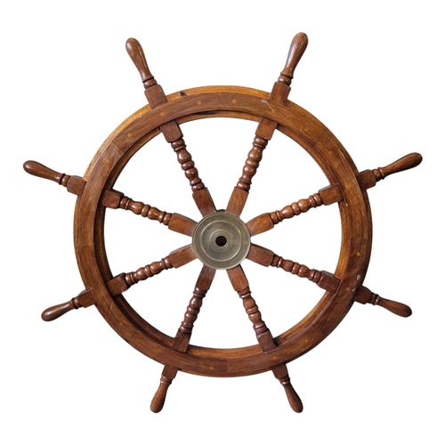 201 - A NOVELTY WOODEN SHIPS WHEEL
With turned spindles.
(91cm x 91cm)

Condition: good overall