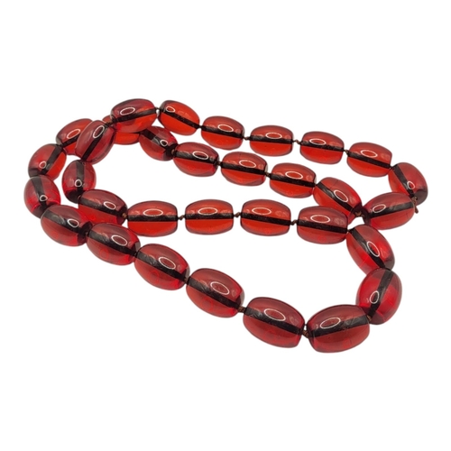 253 - A FAUX CHERRY AMBER BEADED NECKLACE.
(43cm)


Condition: good overall