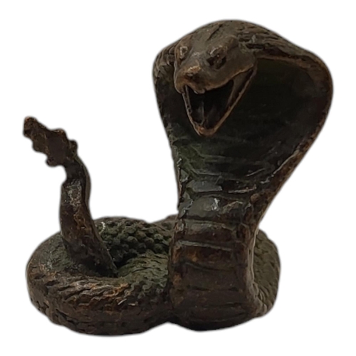 194 - A JAPANESE BRONZE KING COBRA FIGURINE
With four character mark impressed to base.
(4cm)

Condition: ... 