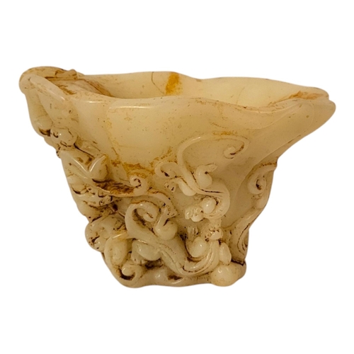 228 - A CHINESE WHITE JADEITE LIBATION CUP
With carved tiger and acanthus decoration.
(16cm x 11cm x 11cm)... 