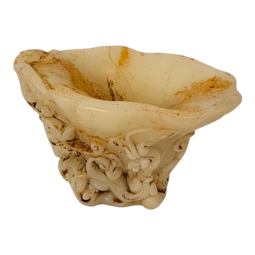 228 - A CHINESE WHITE JADEITE LIBATION CUP
With carved tiger and acanthus decoration.
(16cm x 11cm x 11cm)... 