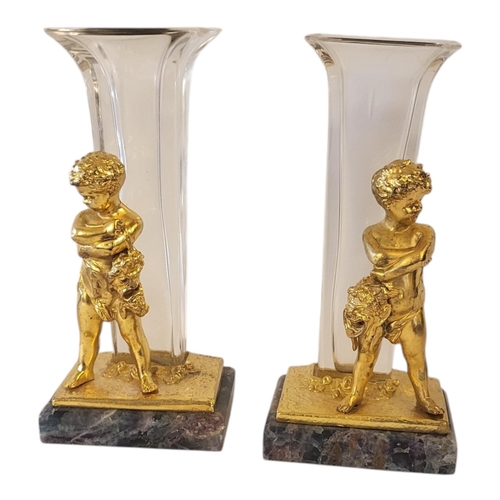 210 - IN THE MANNER OF LOUIS KLEY, FRENCH, 1833 - 1911, A PAIR OF GILT PUTTI AND GLASS VASES
Supported on ... 