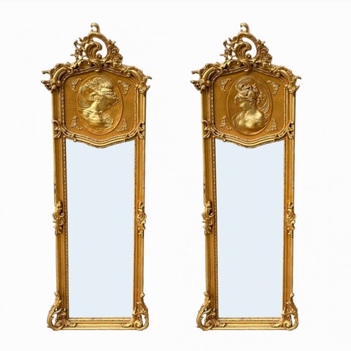 268 - A PAIR OF CONTINENTAL GILT FRAMED MIRRORS CRESTED WITH FEMALE PORTRAIT ROUNDELS
In Art Nouveau style... 