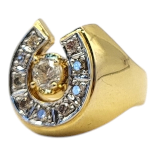 24 - A VINTAGE YELLOW METAL DIAMOND HORSESHOE RING
The arrangement of round cut diamonds forming a horses... 