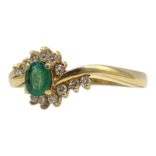 36 - A VINTAGE 18CT GOLD, EMERALD AND DIAMOND RING
Oval cut emerald edged with diamonds
(approx emerald w... 