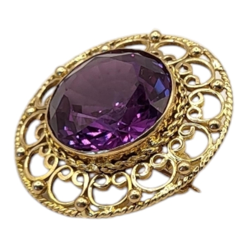 40 - A VINTAGE 14CT GOLD AND AMETHYST BROOCH
The central round cut amethyst in a pierced 14ct gold mount.... 