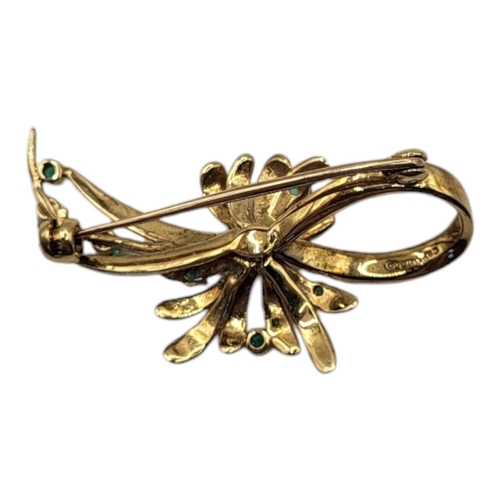 44 - A VINTAGE 9CT GOLD, EMERALD AND SEED PEARL BROOCH
Having an arrangement of round cut emeralds set wi... 