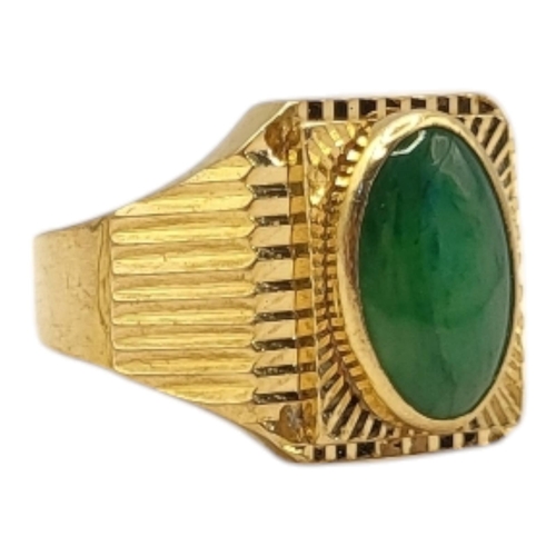 45 - A VINTAGE YELLOW METAL AND CHINESE JADE RING
The cabochon cut stone in reeded mount, bearing Chinese... 