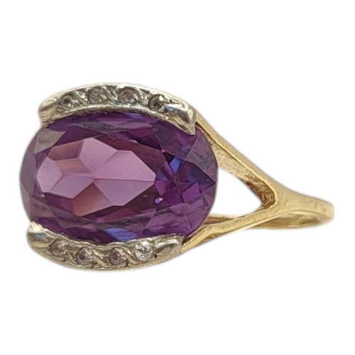 53 - A VINTAGE 18CT GOLD, AMETHYST AND DIAMOND RING
The oval cut amethyst edged with diamonds.
(size J/K)... 