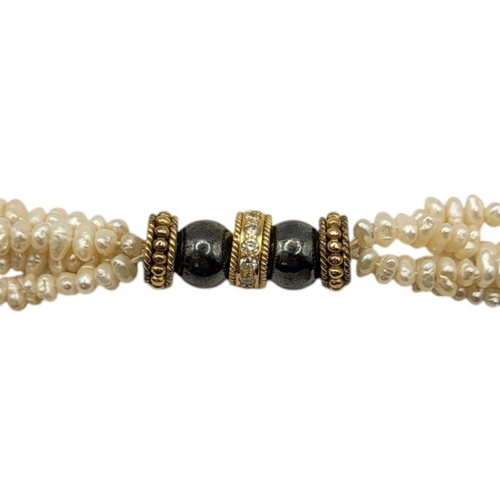 58 - A VINTAGE 9CT GOLD, BLACK PEARL, DIAMOND AND PEARL NECKLACE
The clasp set with two black pearl beads... 