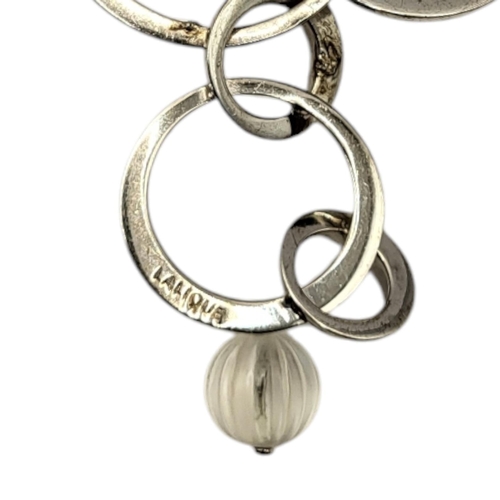 69 - LALIQUE, A VINTAGE SILVER AND FROSTED GLASS NECKLACE
Three spherical glass beads in a pierced circul... 