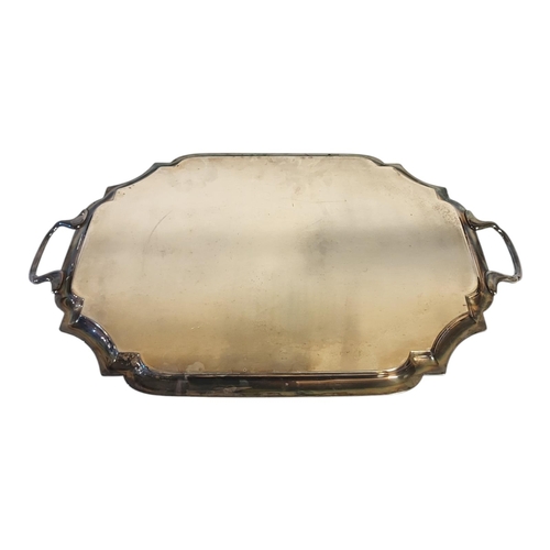 121 - A LARGE EARLY 20TH CENTURY SILVER PLATED TWIN HANDLED BUTLER'S SERVING TRAY
With a reeded piecrust b... 