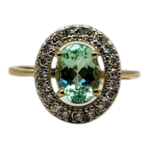 23 - AN 18CT GOLD, TOURMALINE AND DIAMOND RING
The central round cut tourmaline edged with diamonds.
(tou... 