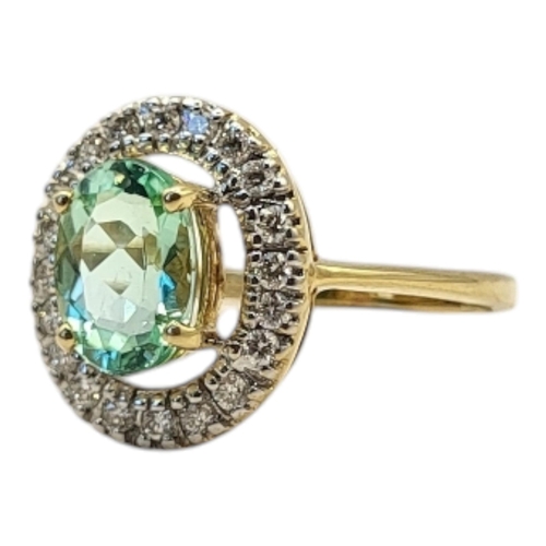 23 - AN 18CT GOLD, TOURMALINE AND DIAMOND RING
The central round cut tourmaline edged with diamonds.
(tou... 