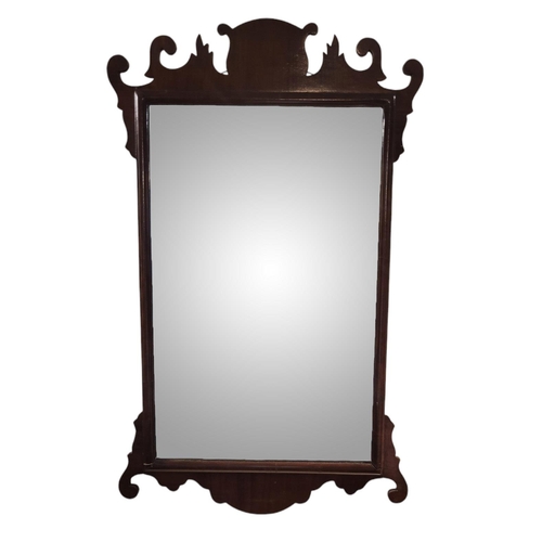 299 - A GEORGIAN DESIGN MAHOGANY FRET MIRROR
Having a carved and shaped frame.
(approx 48cm x 77cm)

Condi... 