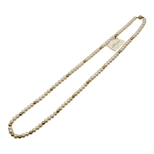 30 - MIKURA, A VINTAGE 18CT GOLD AND PEARL NECKLACE
The single strand of button form freshwater pearls in... 