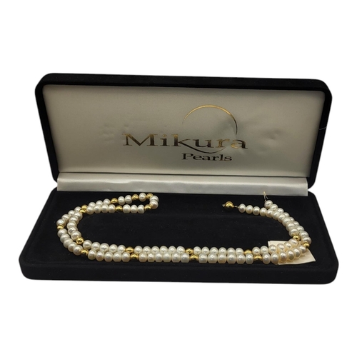 30 - MIKURA, A VINTAGE 18CT GOLD AND PEARL NECKLACE
The single strand of button form freshwater pearls in... 