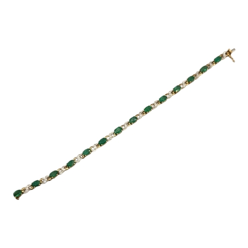 35 - A VINTAGE 9CT GOLD, EMERALD AND DIAMOND BRACELET
The row of oval cut emeralds with pave set diamonds... 