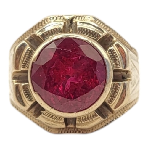 39 - A LARGE CONTINENTAL YELLOW METAL AND RUBY SIGNET RING
The single round cut ruby in a stepped and pie... 