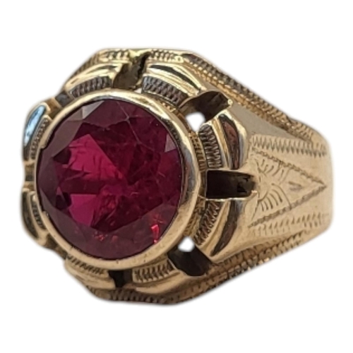 39 - A LARGE CONTINENTAL YELLOW METAL AND RUBY SIGNET RING
The single round cut ruby in a stepped and pie... 