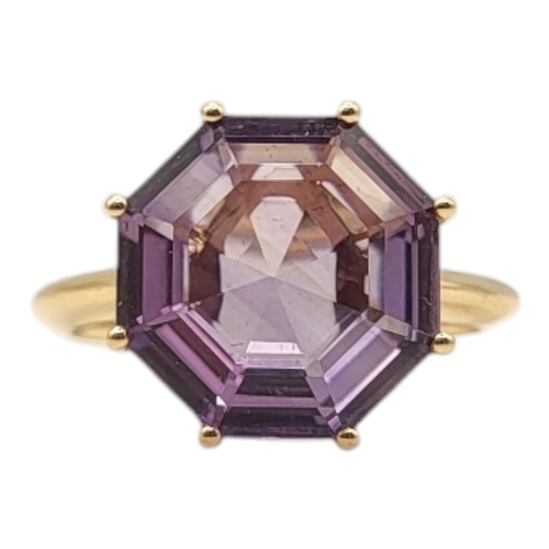 54 - AN UNUSUAL 18CT GOLD AND AMETHYST RING
The octagonal faceted stone on a plain shank.
(size M)

Condi... 