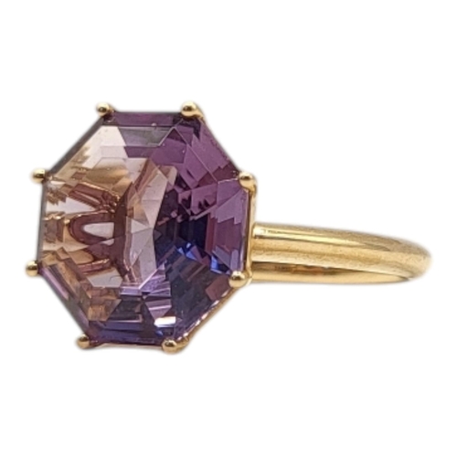 54 - AN UNUSUAL 18CT GOLD AND AMETHYST RING
The octagonal faceted stone on a plain shank.
(size M)

Condi... 