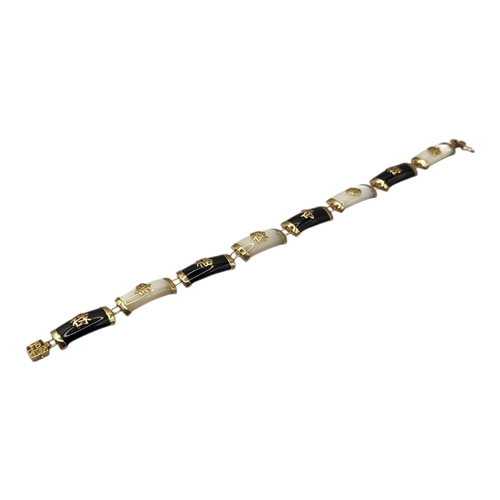 62 - A VINTAGE CHINESE 9CT GOLD MOTHER OF PEARL AND ONYX BRACELET
Convex links with applied Chinese chara... 