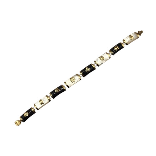 64 - A VINTAGE CHINESE 9CT GOLD, MOTHER OF PEARL AND ONYX BRACELET
Convex links with applied Chinese char... 