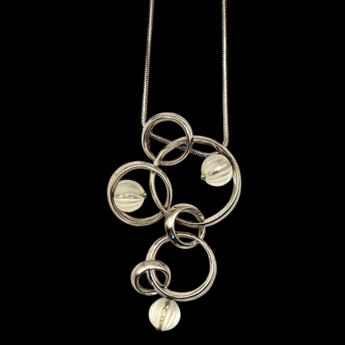 69 - LALIQUE, A VINTAGE SILVER AND FROSTED GLASS NECKLACE
Three spherical glass beads in a pierced circul... 