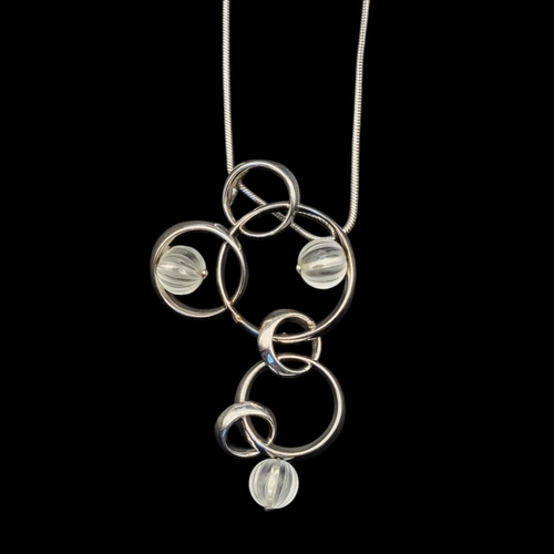 69 - LALIQUE, A VINTAGE SILVER AND FROSTED GLASS NECKLACE
Three spherical glass beads in a pierced circul... 