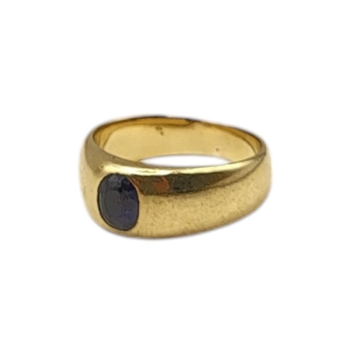 76 - A VINTAGE YELLOW METAL AND SAPPHIRE RING
The single oval cut sapphire in a rub over setting.
(size L... 