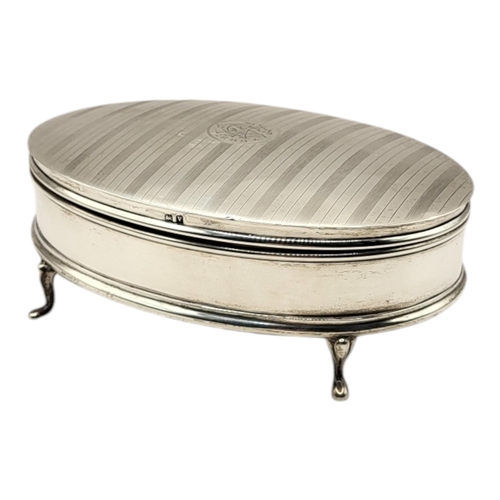 77 - AN EARLY 20TH CENTURY SILVER OVAL JEWELLERY BOX
With engraved initials, engine turned declaration an... 