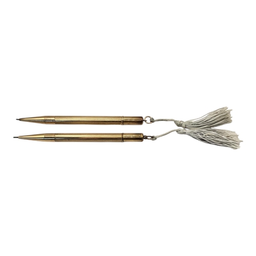 89 - TWO EARLY 20TH CENTURY ROLLED GOLD PROPELLING PENCILS
Twist mechanism with engine turned decoration.... 