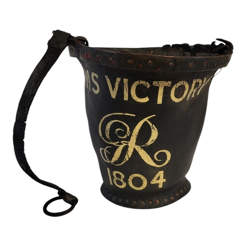 239 - A GEORGIAN LEATHER AND COPPER BANDED SHOT BUCKET
With HMS Victory and GR insignia 1804 later applied... 