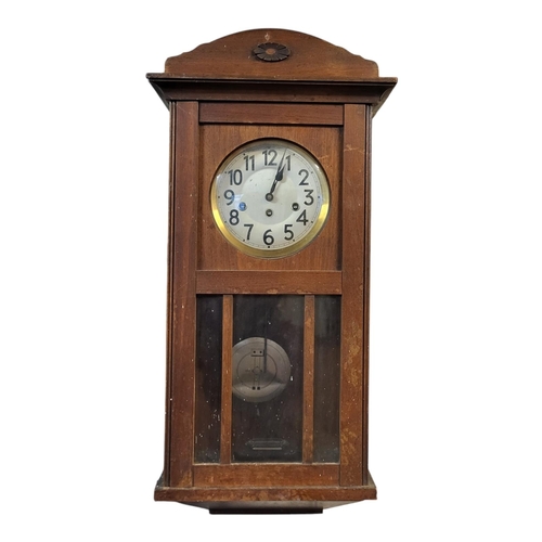 230 - AN EARLY 20TH CENTURY OAK WALL CLOCK
Glazed panel to case and striking Westminster chime striking me... 