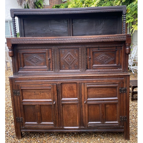 327 - A 17TH/18TH  CENTURY OAK COURT CUPBOARD
With carved lozenge doors, acorn finials above plain panelle... 